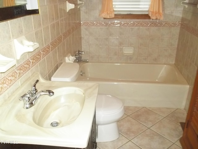313 Milburn Ave, Kingsport, TN 37660 - full bathroom with tile patterned flooring, vanity, tile walls, and bathing tub / shower combination