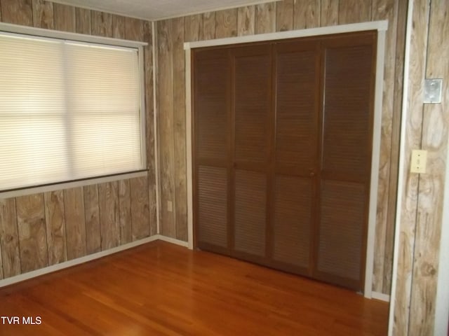 313 Milburn Ave, Kingsport, TN 37660 - unfurnished bedroom with wood finished floors, a closet, and wooden walls
