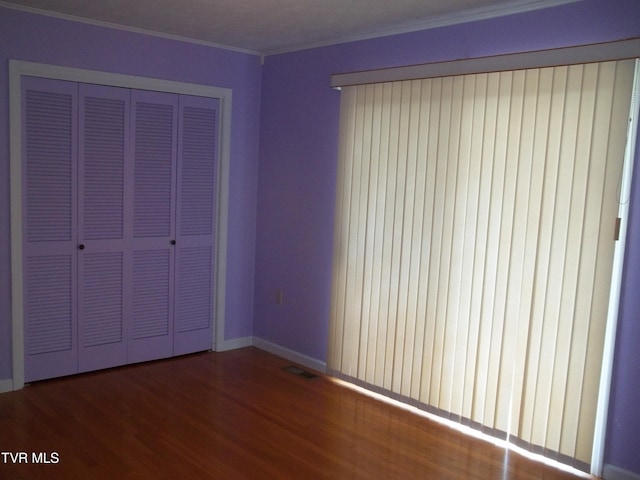 313 Milburn Ave, Kingsport, TN 37660 - unfurnished bedroom with wood finished floors, a closet, and crown molding