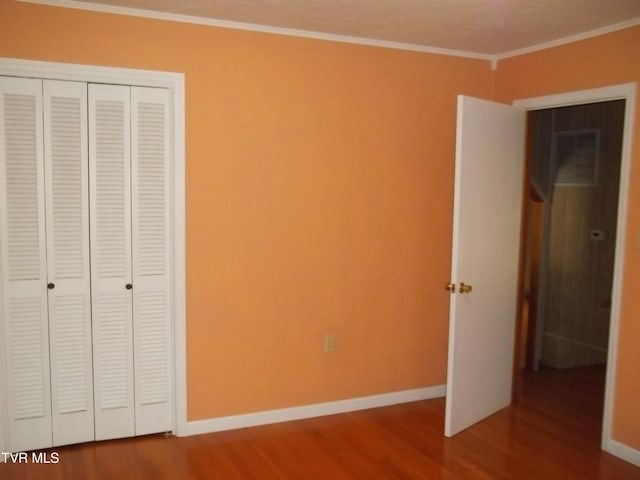 313 Milburn Ave, Kingsport, TN 37660 - unfurnished bedroom featuring wood finished floors, ornamental molding, and a closet