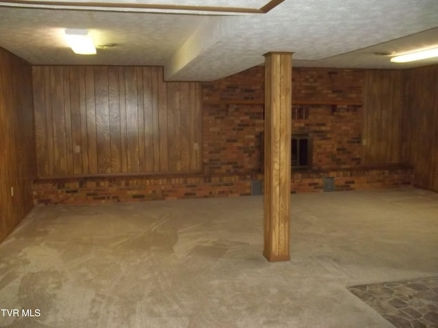 313 Milburn Ave, Kingsport, TN 37660 - finished below grade area featuring wood walls, carpet flooring, a textured ceiling, and brick wall