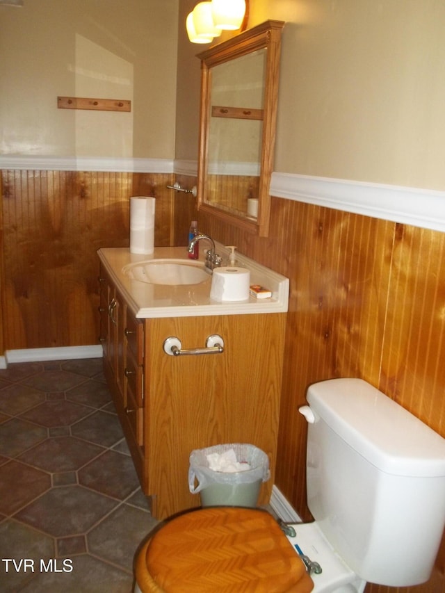 313 Milburn Ave, Kingsport, TN 37660 - half bathroom with vanity, wainscoting, wood walls, and tile patterned flooring