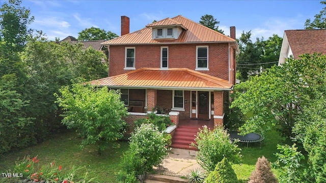 909 Highland Ave, Bristol, VA 24201 - traditional style home featuring a chimney, a trampoline, and brick siding