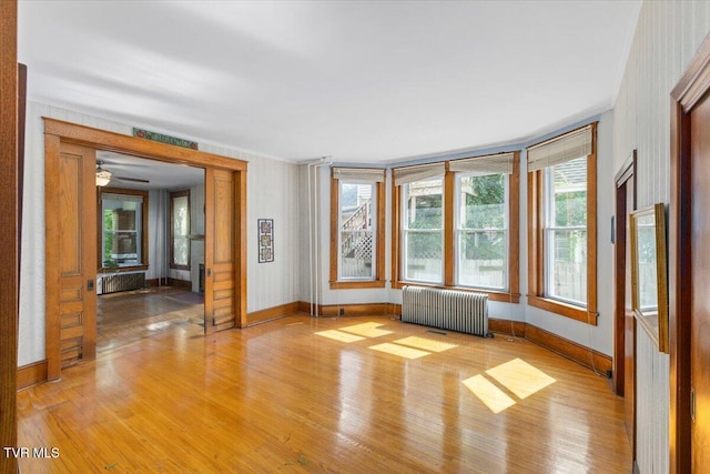 909 Highland Ave, Bristol, VA 24201 - unfurnished room featuring radiator, light wood-type flooring, and ceiling fan