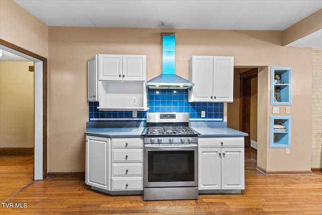 909 Highland Ave, Bristol, VA 24201 - kitchen with stainless steel range with gas stovetop, wall chimney exhaust hood, white cabinetry, and tasteful backsplash