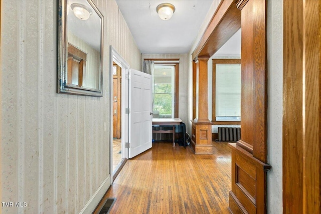 909 Highland Ave, Bristol, VA 24201 - hall featuring radiator, wood finished floors, and wallpapered walls