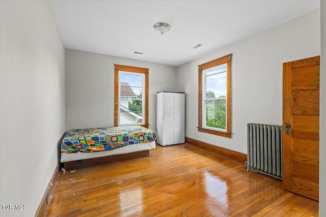 909 Highland Ave, Bristol, VA 24201 - bedroom with radiator and wood finished floors
