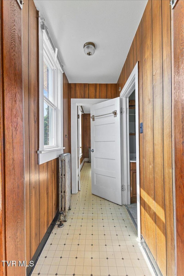 909 Highland Ave, Bristol, VA 24201 - hallway with wooden walls, light flooring, and radiator