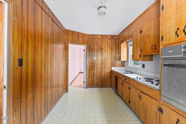 909 Highland Ave, Bristol, VA 24201 - kitchen featuring white electric stovetop, oven, brown cabinetry, wooden walls, and light floors