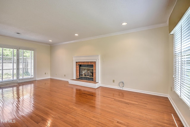 226 Willowbend Ct, Kingsport, TN 37660 - unfurnished living room featuring light wood-style flooring, a textured ceiling, a fireplace, crown molding, and recessed lighting