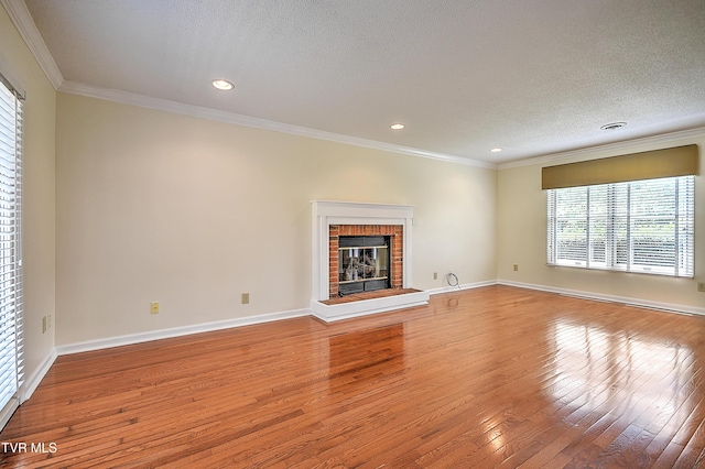 226 Willowbend Ct, Kingsport, TN 37660 - unfurnished living room with hardwood / wood-style flooring, ornamental molding, recessed lighting, a textured ceiling, and a fireplace