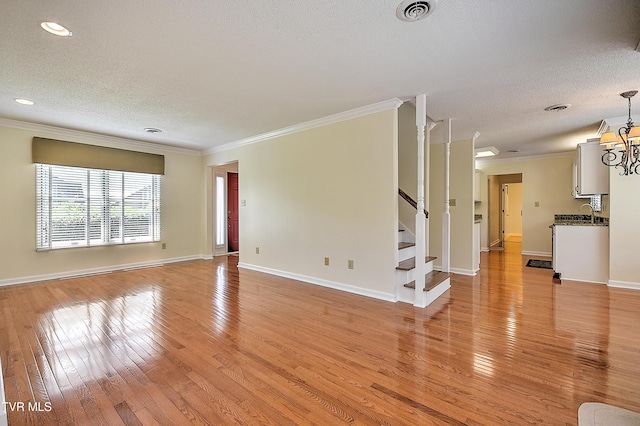 226 Willowbend Ct, Kingsport, TN 37660 - unfurnished living room with a textured ceiling, ornamental molding, light wood finished floors, stairway, and recessed lighting