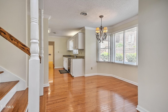 226 Willowbend Ct, Kingsport, TN 37660 - kitchen with a chandelier, light wood-style flooring, ornamental molding, a textured ceiling, and stainless steel dishwasher