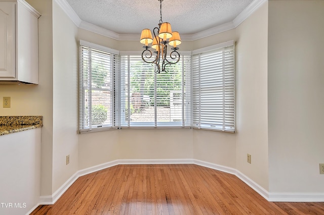 226 Willowbend Ct, Kingsport, TN 37660 - unfurnished dining area featuring a chandelier, light wood-type flooring, a textured ceiling, and crown molding