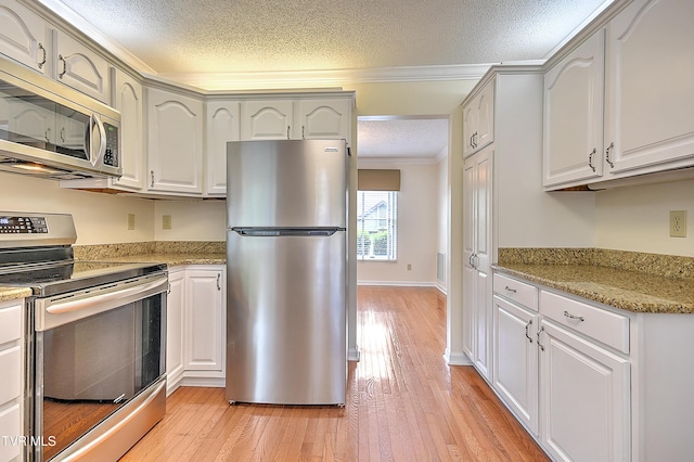 226 Willowbend Ct, Kingsport, TN 37660 - kitchen featuring stainless steel appliances, a textured ceiling, crown molding, light wood finished floors, and light stone countertops