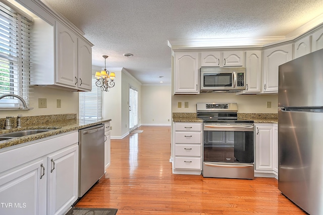 226 Willowbend Ct, Kingsport, TN 37660 - kitchen with stainless steel appliances, a textured ceiling, healthy amount of natural light, crown molding, and stone counters