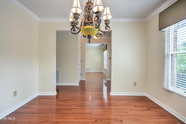 226 Willowbend Ct, Kingsport, TN 37660 - empty room with a chandelier, wood finished floors, ornamental molding, and a textured ceiling