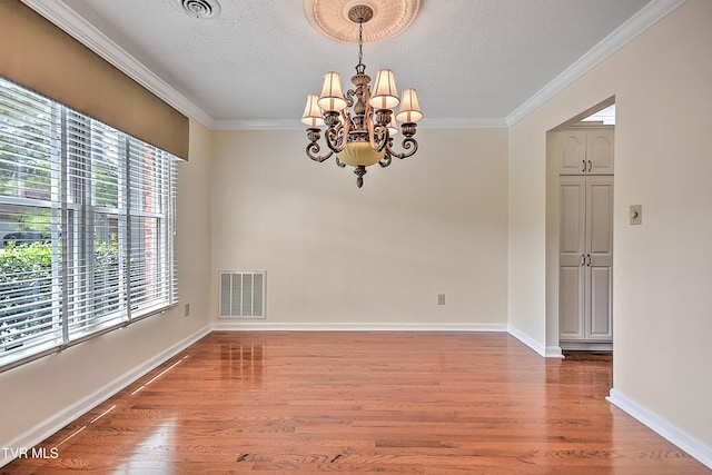 226 Willowbend Ct, Kingsport, TN 37660 - spare room with light wood-type flooring, a chandelier, ornamental molding, and a textured ceiling