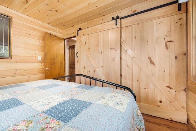 1524 Redwood Dr, Kingsport, TN 37664 - bedroom with a barn door, wood finished floors, wood walls, and wood ceiling