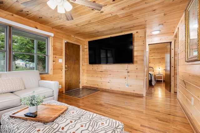 1524 Redwood Dr, Kingsport, TN 37664 - living area with wood ceiling, wooden walls, a ceiling fan, and light wood-style flooring