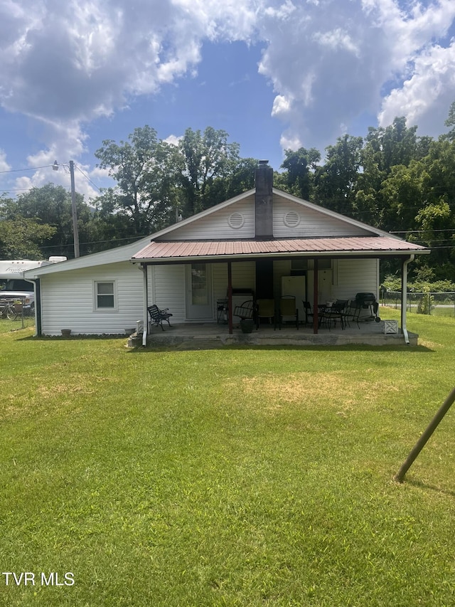 119 Liberty Hollow Rd, Elizabethton, TN 37643 - back of house featuring a yard, a metal roof, and a chimney