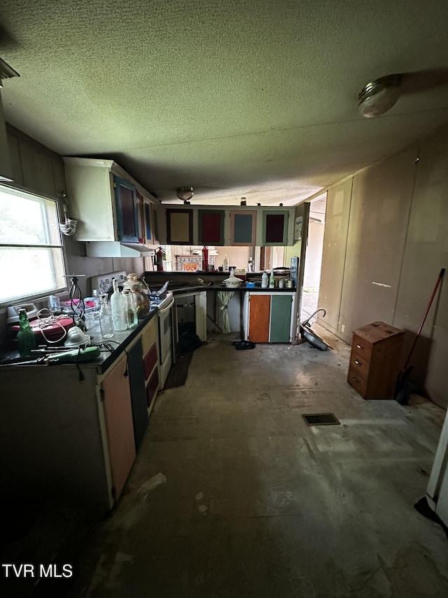 120 Hensley Loop, Jonesborough, TN 37659 - kitchen featuring dark countertops, stove, and a textured ceiling