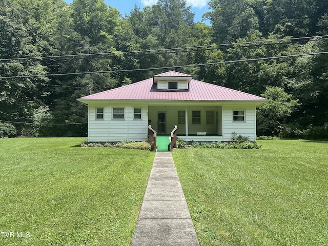 2065 Coeburn Rd, Clintwood, VA 24228 - bungalow featuring covered porch, a front yard, and a metal roof