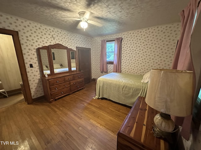 2065 Coeburn Rd, Clintwood, VA 24228 - bedroom with wallpapered walls, hardwood / wood-style floors, and ceiling fan