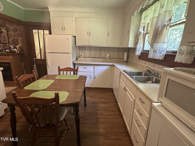 2065 Coeburn Rd, Clintwood, VA 24228 - kitchen featuring white appliances, light countertops, white cabinets, ornamental molding, and dark wood-type flooring