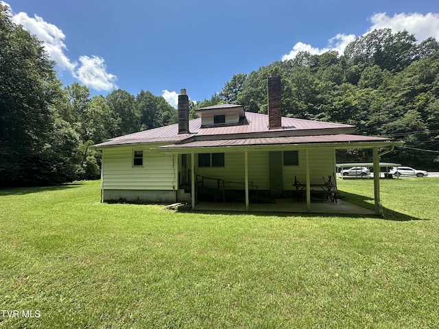 2065 Coeburn Rd, Clintwood, VA 24228 - rear view of property with a chimney, a lawn, a metal roof, and a wooded view