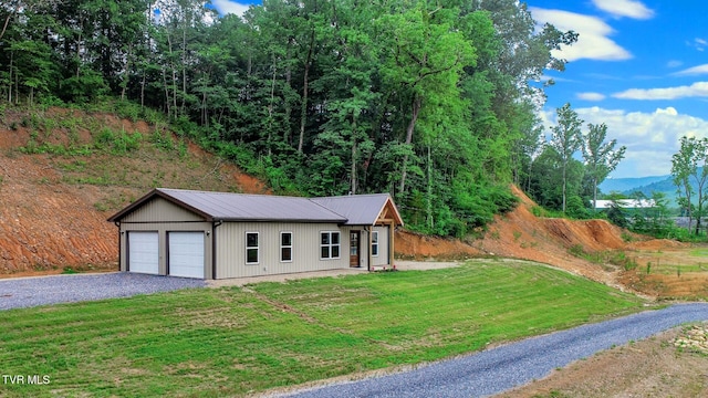1976 Hartford Rd, Cosby, TN 37722 - view of front of property with a metal roof, a front yard, an outdoor structure, a garage, and a mountain view