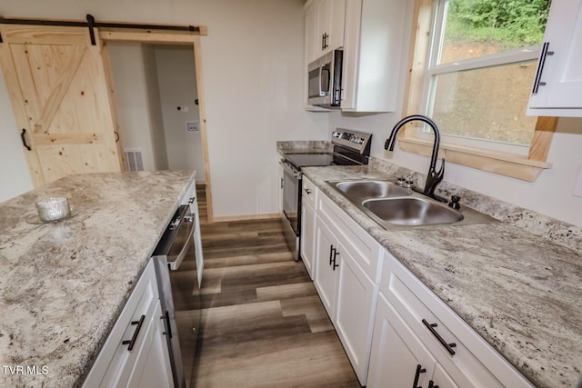 1976 Hartford Rd, Cosby, TN 37722 - kitchen featuring stainless steel appliances, dark wood-style flooring, and white cabinets