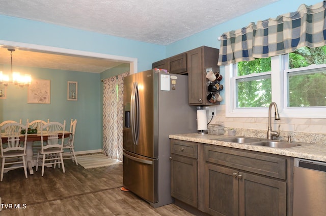 2165 Steadman St, Kingsport, TN 37664 - kitchen with appliances with stainless steel finishes, dark wood-type flooring, light countertops, a textured ceiling, and decorative light fixtures