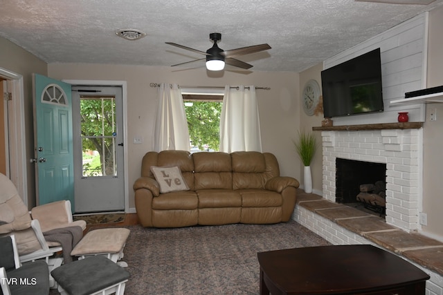 2165 Steadman St, Kingsport, TN 37664 - living room featuring ceiling fan, plenty of natural light, a brick fireplace, and a textured ceiling