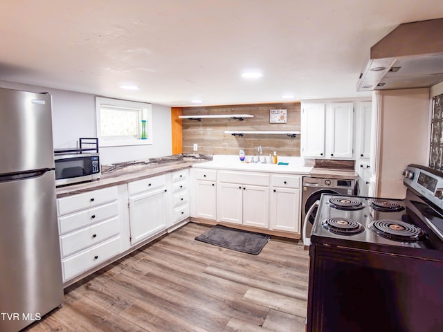 719 E Maple St, Johnson City, TN 37601 - kitchen with appliances with stainless steel finishes, washer / dryer, white cabinets, light wood-style flooring, and recessed lighting