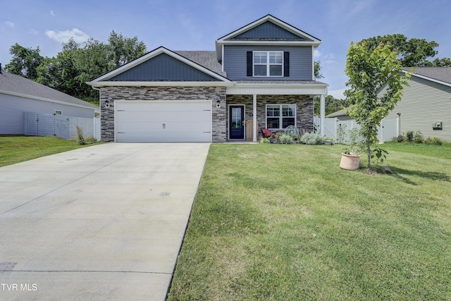 5402 Wildlife Cir, Piney Flats, TN 37686 - view of front of property featuring an attached garage, concrete driveway, a front yard, covered porch, and stone siding