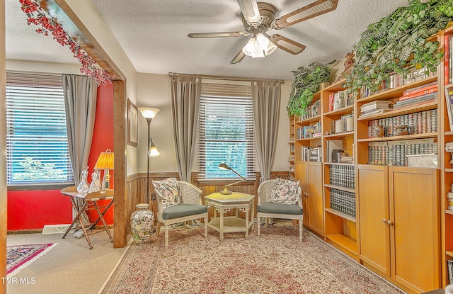 4700 Weaver Pike, Bluff City, TN 37618 - sitting room featuring a textured ceiling, ceiling fan, plenty of natural light, a wainscoted wall, and carpet