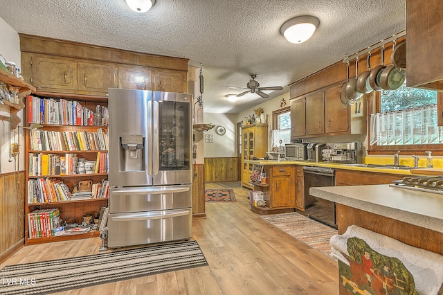 4700 Weaver Pike, Bluff City, TN 37618 - kitchen with stainless steel appliances, wooden walls, a wainscoted wall, a textured ceiling, and light wood finished floors