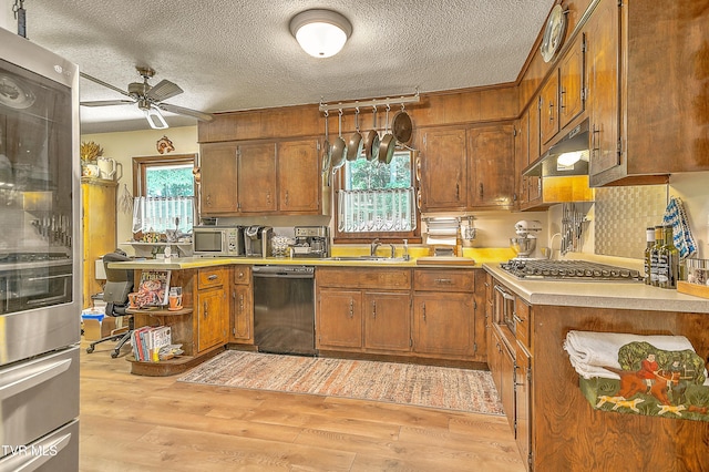 4700 Weaver Pike, Bluff City, TN 37618 - kitchen featuring stainless steel appliances, a ceiling fan, light countertops, brown cabinetry, and light wood-style flooring