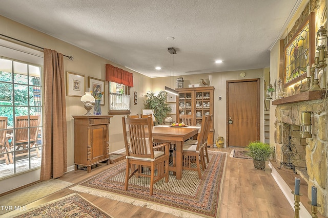 4700 Weaver Pike, Bluff City, TN 37618 - dining space with light wood-style floors, a textured ceiling, recessed lighting, ornamental molding, and a fireplace