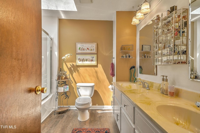 4700 Weaver Pike, Bluff City, TN 37618 - full bathroom featuring double vanity, wood finished floors, and bath / shower combo with glass door