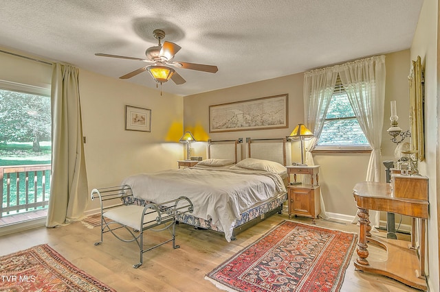 4700 Weaver Pike, Bluff City, TN 37618 - bedroom with access to outside, a textured ceiling, light wood finished floors, and a ceiling fan