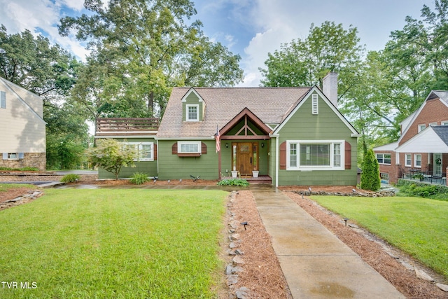 1121 Watauga St, Kingsport, TN 37660 - cape cod home featuring a front lawn, a chimney, and roof with shingles