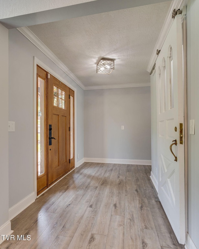 1121 Watauga St, Kingsport, TN 37660 - foyer entrance with crown molding, a textured ceiling, and light wood-style floors