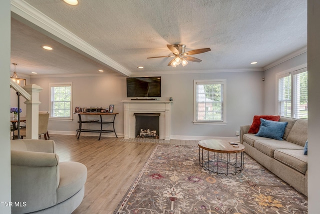 1121 Watauga St, Kingsport, TN 37660 - living room with wood finished floors, recessed lighting, a textured ceiling, a fireplace with flush hearth, and ceiling fan