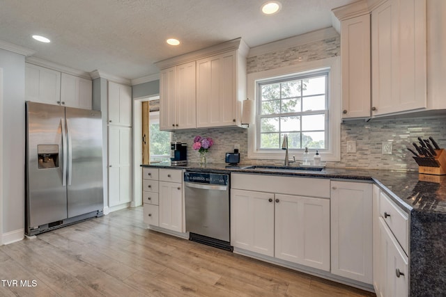 1121 Watauga St, Kingsport, TN 37660 - kitchen with appliances with stainless steel finishes, crown molding, backsplash, recessed lighting, and light wood finished floors