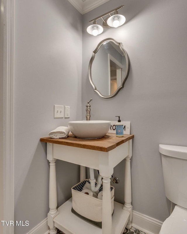 1121 Watauga St, Kingsport, TN 37660 - bathroom featuring a sink and baseboards