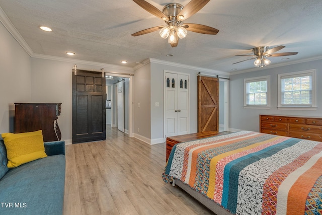 1121 Watauga St, Kingsport, TN 37660 - bedroom with a barn door, light wood finished floors, a textured ceiling, recessed lighting, and ornamental molding
