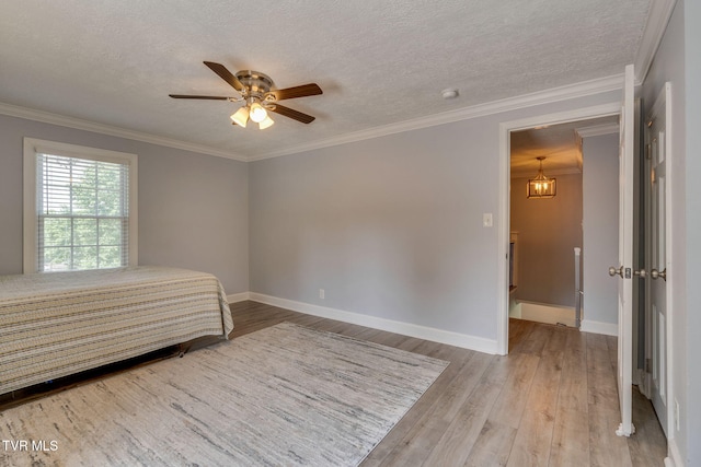 1121 Watauga St, Kingsport, TN 37660 - bedroom with wood finished floors, a textured ceiling, a ceiling fan, and ornamental molding