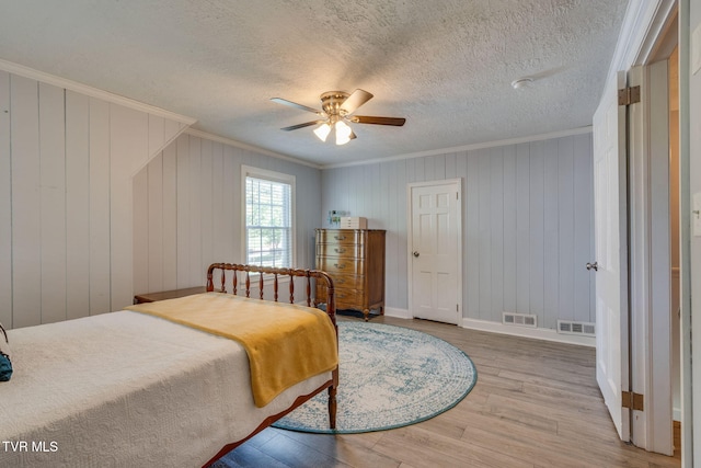 1121 Watauga St, Kingsport, TN 37660 - bedroom featuring crown molding, wood finished floors, a ceiling fan, and a textured ceiling
